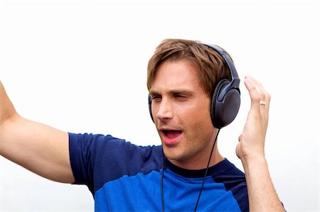 An attractive man with headphones and a blue vestA handsome man jamming out to music Stock Photo - Budget Royalty-Free & Subscription, Code: 400-05160118