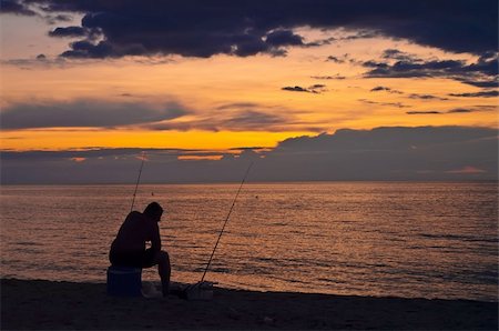 simsearch:400-07748817,k - A fisherman on the beach. Fishing at sunset. Stock Photo - Budget Royalty-Free & Subscription, Code: 400-05161859