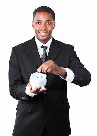 simsearch:400-05715208,k - Young Afro-American businessman putting money in his piggy bank and smiling at the camera Stock Photo - Budget Royalty-Free & Subscription, Code: 400-05162066