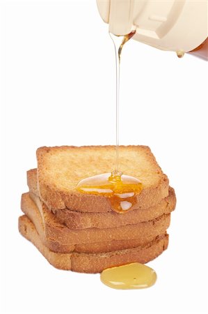 simsearch:400-05135233,k - Pouring honey over the pile of toasts on white background Foto de stock - Super Valor sin royalties y Suscripción, Código: 400-05174224