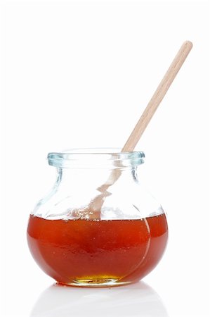 simsearch:400-05135233,k - Honey on glass jar isolated on white background. Shallow depth of field Foto de stock - Super Valor sin royalties y Suscripción, Código: 400-05174225