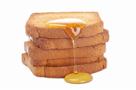 simsearch:400-05135233,k - Honey over the pile of toasts on white background Foto de stock - Super Valor sin royalties y Suscripción, Código: 400-05174223