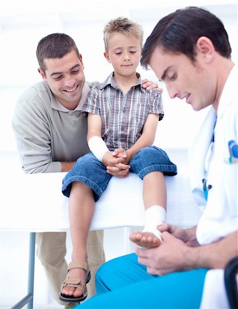 doctor with gloves with child - Doctor bandaging a child's foot in hospital Stock Photo - Budget Royalty-Free & Subscription, Code: 400-05179307