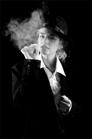 picture young girl smoking cigarette - beautiful girl in a man's suit, smoke on black background Stock Photo - Budget Royalty-Free & Subscription, Code: 400-05185699