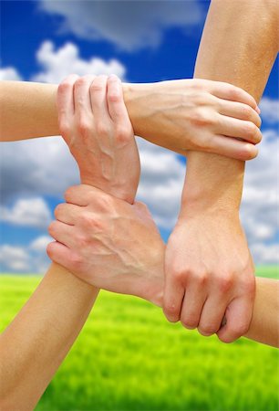 simsearch:700-00046258,k - Linked hands on a sky background symbolizing teamwork and friendship Stock Photo - Budget Royalty-Free & Subscription, Code: 400-05187481