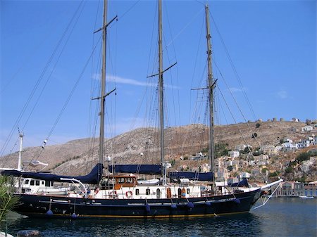 simsearch:400-04793526,k - Sailing vessel in the harbor of the Greek city. Symi Island Stock Photo - Budget Royalty-Free & Subscription, Code: 400-05180110