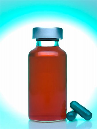 simsearch:400-05713485,k - Close up of a vial full of red liquid, green pills aside. Stock Photo - Budget Royalty-Free & Subscription, Code: 400-05196082