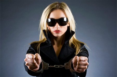 sexy woman with handcuffs on over dark background Stock Photo - Budget Royalty-Free & Subscription, Code: 400-05192139