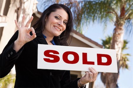 Happy Attractive Hispanic Woman Holding Sold Sign In Front of House. Stock Photo - Budget Royalty-Free & Subscription, Code: 400-05193538