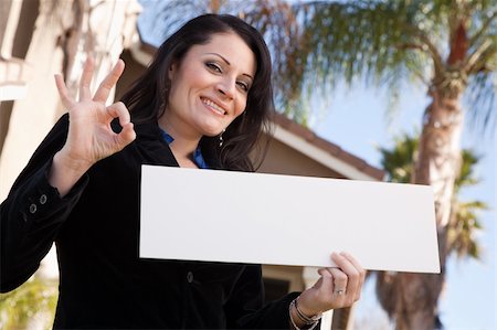 simsearch:693-03308239,k - Happy Attractive Hispanic Woman Holding Blank Sign in Front of House. Stock Photo - Budget Royalty-Free & Subscription, Code: 400-05193539