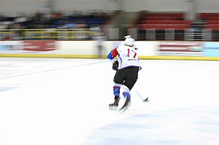 Ice hockey player in motion on the ice Stock Photo - Budget Royalty-Free & Subscription, Code: 400-05205984