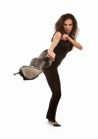 Tough woman in high heels kicking at camera Stock Photo - Budget Royalty-Free & Subscription, Code: 400-05206309