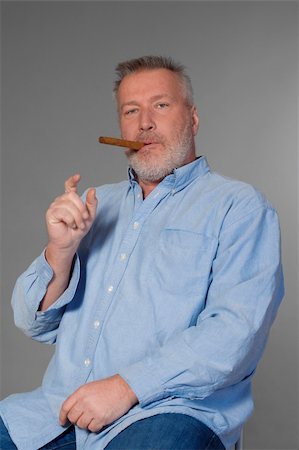 simsearch:400-05207678,k - studio portrait of a middle aged man in shirt with a cigar Stock Photo - Budget Royalty-Free & Subscription, Code: 400-05207678