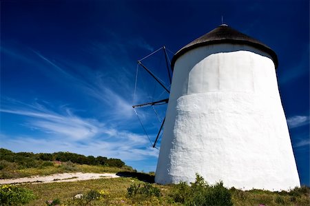 simsearch:400-05319608,k - A path leading to a windmill with blue skies in the background and green grass in the foreground. Windmill shot taken from behind. Stock Photo - Budget Royalty-Free & Subscription, Code: 400-05209568