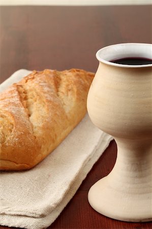 Chalice with red wine and bread in background. Shallow dof, copy space Stock Photo - Budget Royalty-Free & Subscription, Code: 400-05209613