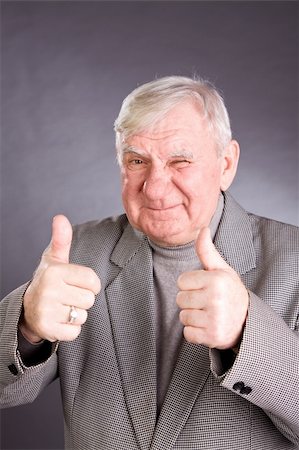 simsearch:400-06142278,k - senior man showing thumb up on a grey background Stock Photo - Budget Royalty-Free & Subscription, Code: 400-05200155