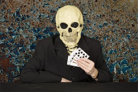 simsearch:400-04275576,k - Horrible cardsharper in a mask - the skull sitting at the table Photographie de stock - Aubaine LD & Abonnement, Code: 400-05218097