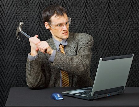 evil faces for emotions - Comical person intends to break the computer with a hammer Stock Photo - Budget Royalty-Free & Subscription, Code: 400-05218103