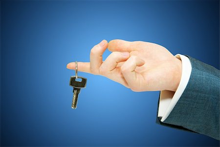 simsearch:400-04852236,k - hand holds a key isolated on blue Stock Photo - Budget Royalty-Free & Subscription, Code: 400-05218511