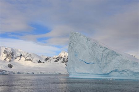 simsearch:400-04299237,k - Iceberg and landscape in Antarctica with clouds in background Stock Photo - Budget Royalty-Free & Subscription, Code: 400-05211155