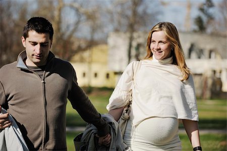 simsearch:400-04659391,k - happy young married family couple outdoor in nature have fun and waiting baby and representing young family growth and pregnancy concept Stock Photo - Budget Royalty-Free & Subscription, Code: 400-05225125