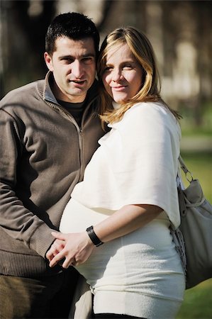 simsearch:400-04659391,k - happy young married family couple outdoor in nature have fun and waiting baby and representing young family growth and pregnancy concept Stock Photo - Budget Royalty-Free & Subscription, Code: 400-05225122