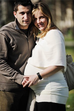 simsearch:400-04659391,k - happy young married family couple outdoor in nature have fun and waiting baby and representing young family growth and pregnancy concept Stock Photo - Budget Royalty-Free & Subscription, Code: 400-05225123