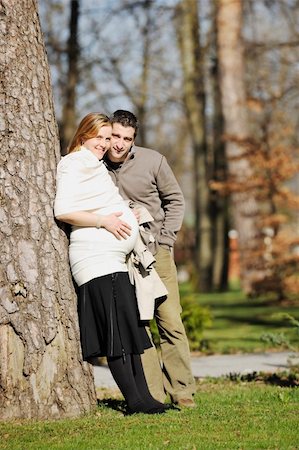 simsearch:400-04659391,k - happy young married family couple outdoor in nature have fun and waiting baby and representing young family growth and pregnancy concept Stock Photo - Budget Royalty-Free & Subscription, Code: 400-05225134