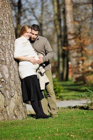 simsearch:400-04659391,k - happy young married family couple outdoor in nature have fun and waiting baby and representing young family growth and pregnancy concept Stock Photo - Budget Royalty-Free & Subscription, Code: 400-05225135