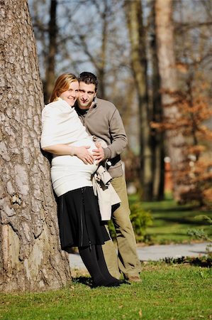 simsearch:400-04659391,k - happy young married family couple outdoor in nature have fun and waiting baby and representing young family growth and pregnancy concept Stock Photo - Budget Royalty-Free & Subscription, Code: 400-05225136