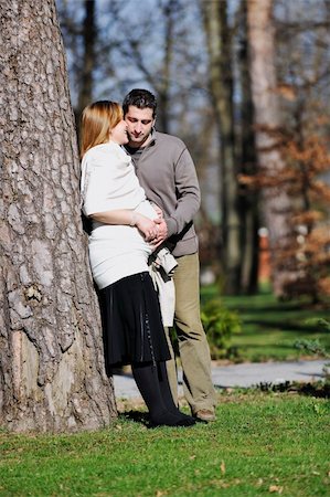 simsearch:400-04659391,k - happy young married family couple outdoor in nature have fun and waiting baby and representing young family growth and pregnancy concept Stock Photo - Budget Royalty-Free & Subscription, Code: 400-05225138