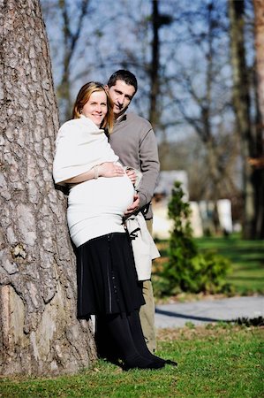 simsearch:400-04659391,k - happy young married family couple outdoor in nature have fun and waiting baby and representing young family growth and pregnancy concept Stock Photo - Budget Royalty-Free & Subscription, Code: 400-05225147