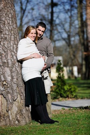 simsearch:400-04659391,k - happy young married family couple outdoor in nature have fun and waiting baby and representing young family growth and pregnancy concept Stock Photo - Budget Royalty-Free & Subscription, Code: 400-05225149