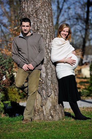 simsearch:400-04659391,k - happy young married family couple outdoor in nature have fun and waiting baby and representing young family growth and pregnancy concept Stock Photo - Budget Royalty-Free & Subscription, Code: 400-05225155