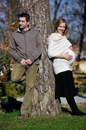 simsearch:400-04659391,k - happy young married family couple outdoor in nature have fun and waiting baby and representing young family growth and pregnancy concept Stock Photo - Budget Royalty-Free & Subscription, Code: 400-05225158