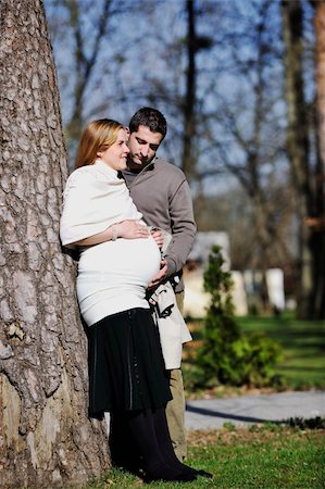 simsearch:400-04659391,k - happy young married family couple outdoor in nature have fun and waiting baby and representing young family growth and pregnancy concept Stock Photo - Budget Royalty-Free & Subscription, Code: 400-05225150
