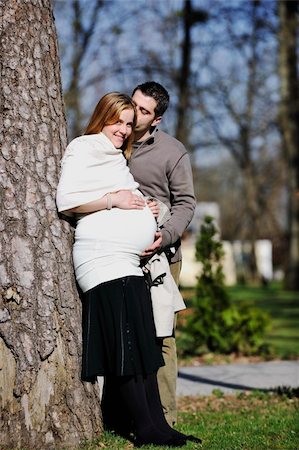 simsearch:400-04659391,k - happy young married family couple outdoor in nature have fun and waiting baby and representing young family growth and pregnancy concept Stock Photo - Budget Royalty-Free & Subscription, Code: 400-05225151