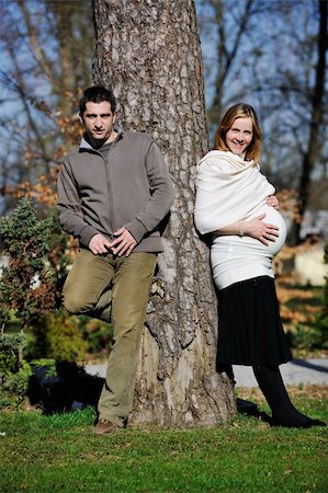 simsearch:400-04659391,k - happy young married family couple outdoor in nature have fun and waiting baby and representing young family growth and pregnancy concept Stock Photo - Budget Royalty-Free & Subscription, Code: 400-05225153