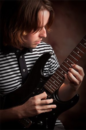 simsearch:400-04863651,k - Young Musician Plays His Electric Guitar with Dramatic Lighting. Stock Photo - Budget Royalty-Free & Subscription, Code: 400-05228438