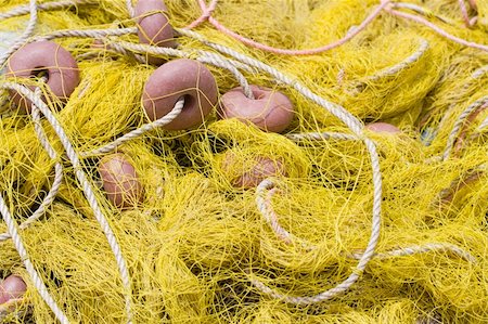 Tangled nylon yellow, fishing tackle close-up: net, float, cord Stock Photo - Budget Royalty-Free & Subscription, Code: 400-05229656