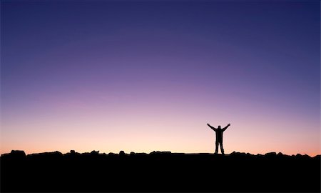 silhouette of man standing in a mountain top - Silhouette of a man raising his hands into the sunrise after conquering a summit Stock Photo - Budget Royalty-Free & Subscription, Code: 400-05222746