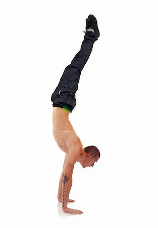 young breakdancer in move against grey background - hand stand Stock Photo - Budget Royalty-Free & Subscription, Code: 400-05238791