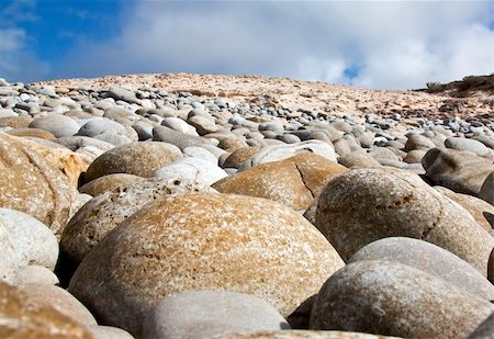 simsearch:400-04016023,k - Round rocks on the beach with blue sky and clouds in the background Stock Photo - Budget Royalty-Free & Subscription, Code: 400-05230558