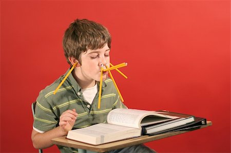 kid goofying off while studying Stock Photo - Budget Royalty-Free & Subscription, Code: 400-05232714