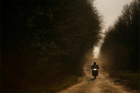simsearch:400-05017762,k - A motorcycle and its rider are silhouetted on an off-road track in Romania Stock Photo - Budget Royalty-Free & Subscription, Code: 400-05233150