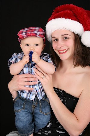 Beautiful christmas mother and son on a black background Stock Photo - Budget Royalty-Free & Subscription, Code: 400-05248995
