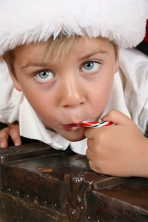 Close up of christmas boy eating a candy cane Stock Photo - Budget Royalty-Free & Subscription, Code: 400-05248992