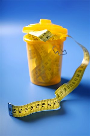 simsearch:400-04407139,k - Centimeter tape meter on the trash, end of diet care metaphor Stock Photo - Budget Royalty-Free & Subscription, Code: 400-05240014