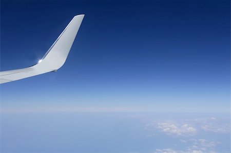 Aircraft wing detail flying high up in deep blue sky Stock Photo - Budget Royalty-Free & Subscription, Code: 400-05240100