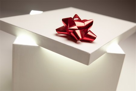 Gift Box with Red Bow Lid Revealing Very Bright Contents on a Gradated Background. Stock Photo - Budget Royalty-Free & Subscription, Code: 400-05240716